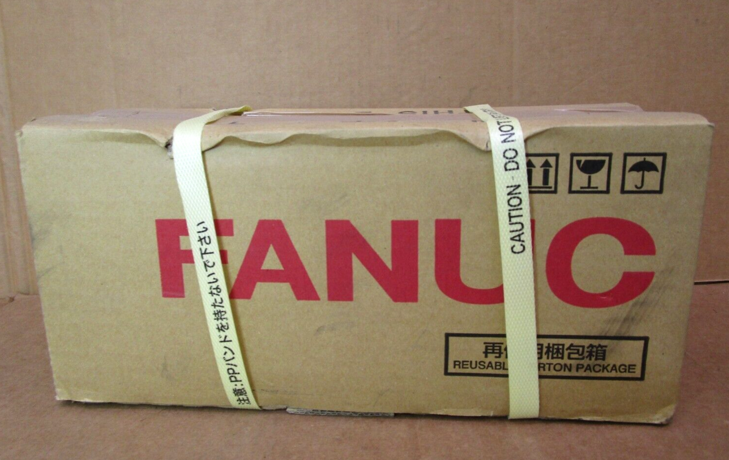 FANUC A06B-0215-B805 Servo Motor box with logo, caution labels, and Japanese text.