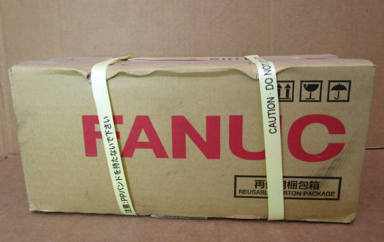 FANUC A06B-0215-B805 Servo Motor box with logo, caution labels, and Japanese text.