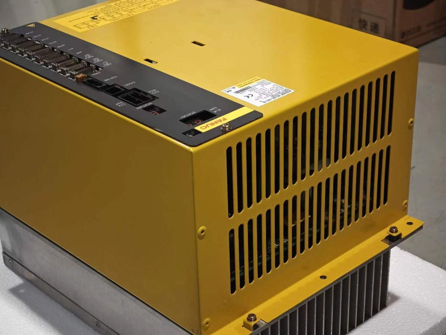 FANUC A06B-6134-H303#A servo drive, yellow industrial equipment with ports and display.