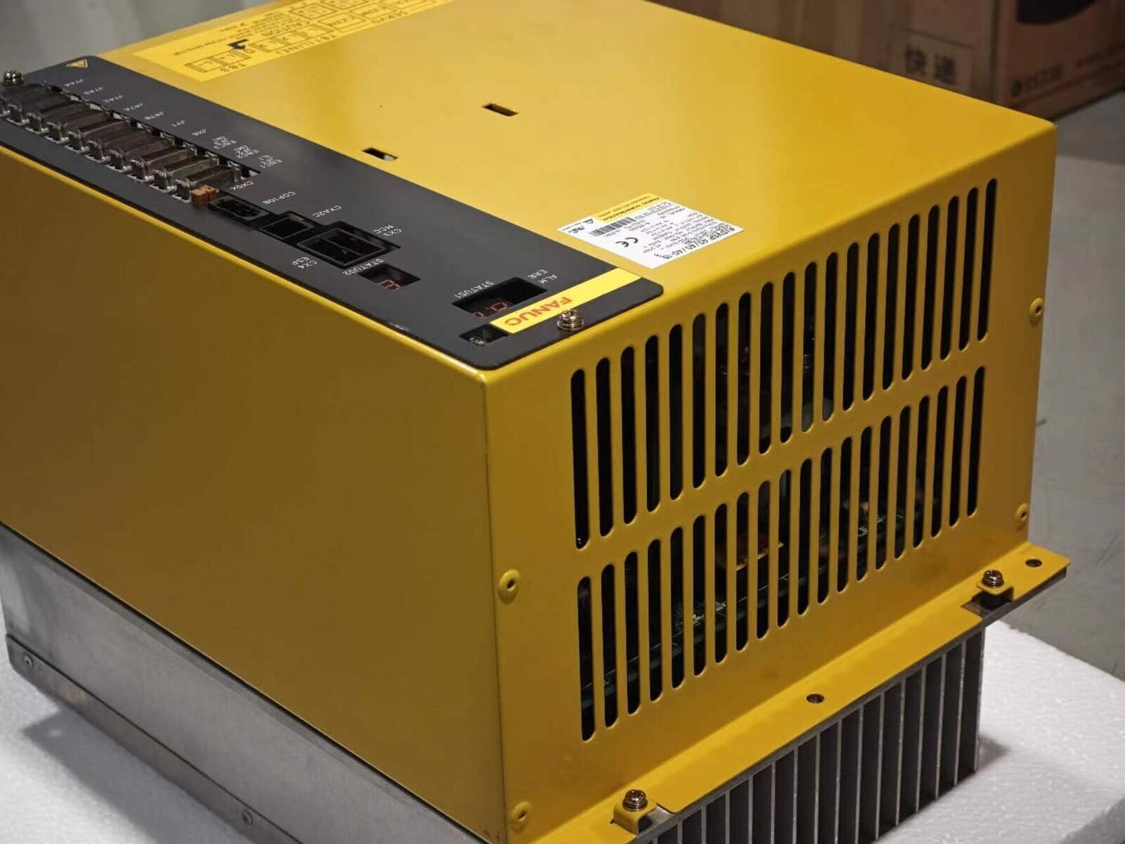 FANUC A06B-6134-H303#A servo drive, yellow industrial equipment with ports and display.