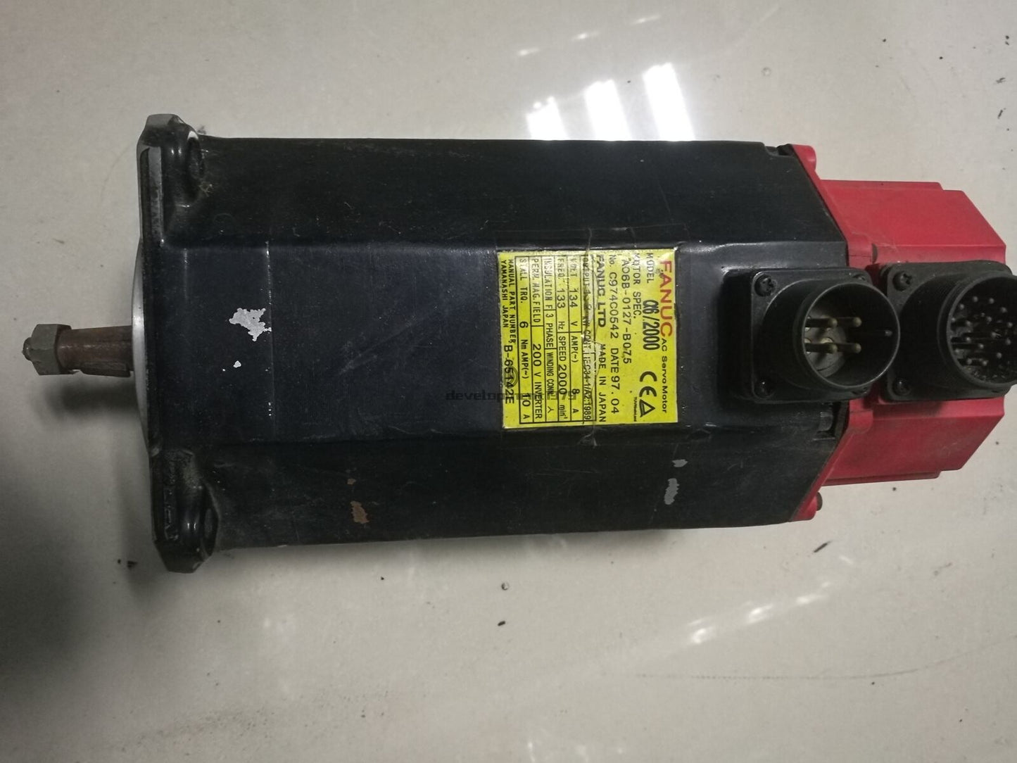 FANUC A06B-0127-B075 Servo Motor with yellow specification label, industrial automation part