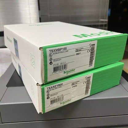 Schneider Electric TSXMBP100 and TSXAEY800 Modicon industrial automation parts boxes, PCMCIA communication cards.