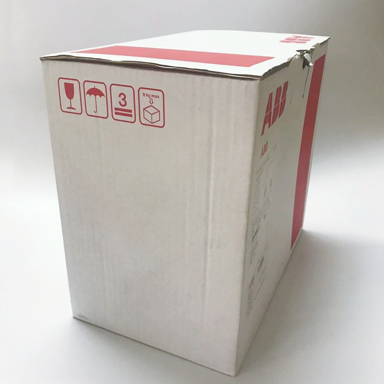 ABB PSE105-600-70 Soft Starter shipping box. White cardboard with red ABB logo, handling symbols and product information.