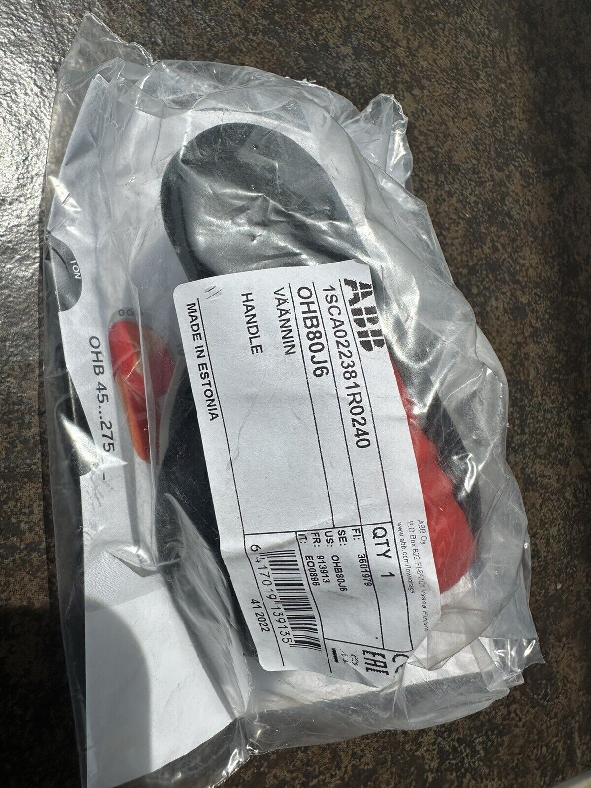 ABB OHB80J6 Pistol Handle in packaging, made in Estonia. High-quality handle for industrial use.