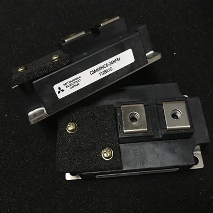 Mitsubishi CM400HC6-24NFM IGBT module, black component with metallic plates and screws, industrial automation part, Japan.