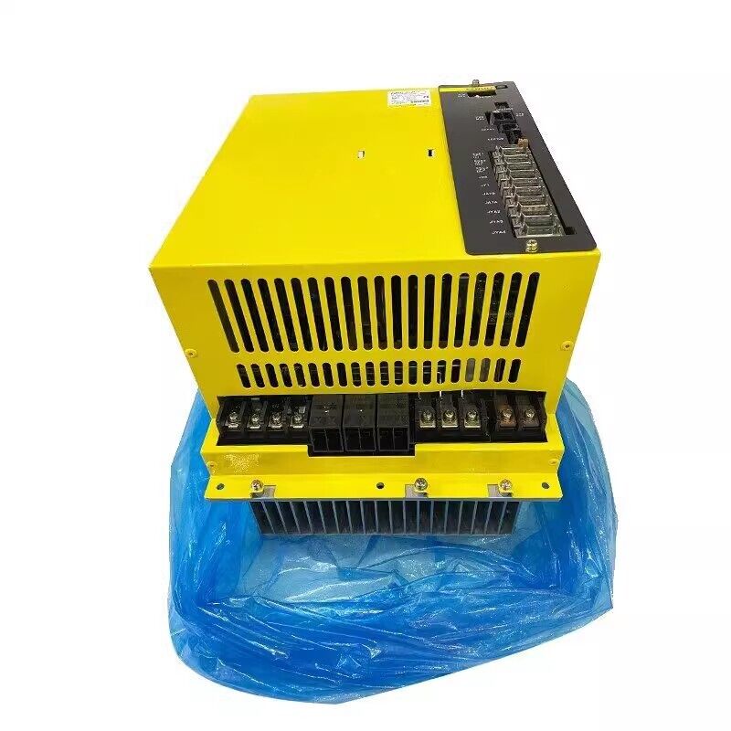 FANUC A06B-6134-H303#A Servo Drive, yellow industrial automation equipment,  heat sink, placed in blue wrapping