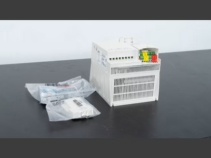 ABB ACS355-03U-15A6-4 industrial drive, white housing, wiring connections, and accessories.