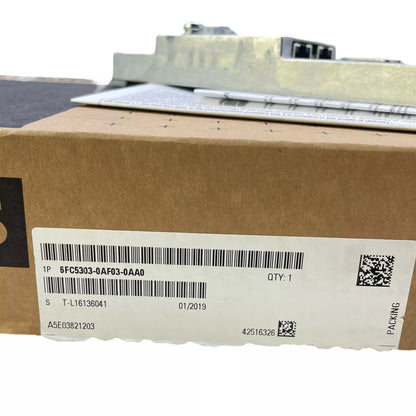 Siemens 6FC5303-0AF03-0AA0 PLC control panel in a cardboard box. Part number, quantity, and packing label visible.