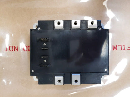 Mitsubishi PM150CVA120 IGBT Module, industrial automation part, black module with connectors, top view.