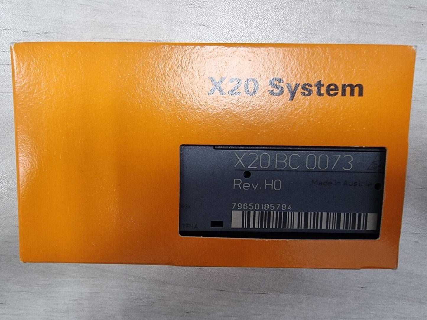 B&R X20 System BC 0073 PLC controller module in orange packaging, Rev. HO, Made in Austria. Industrial automation component.