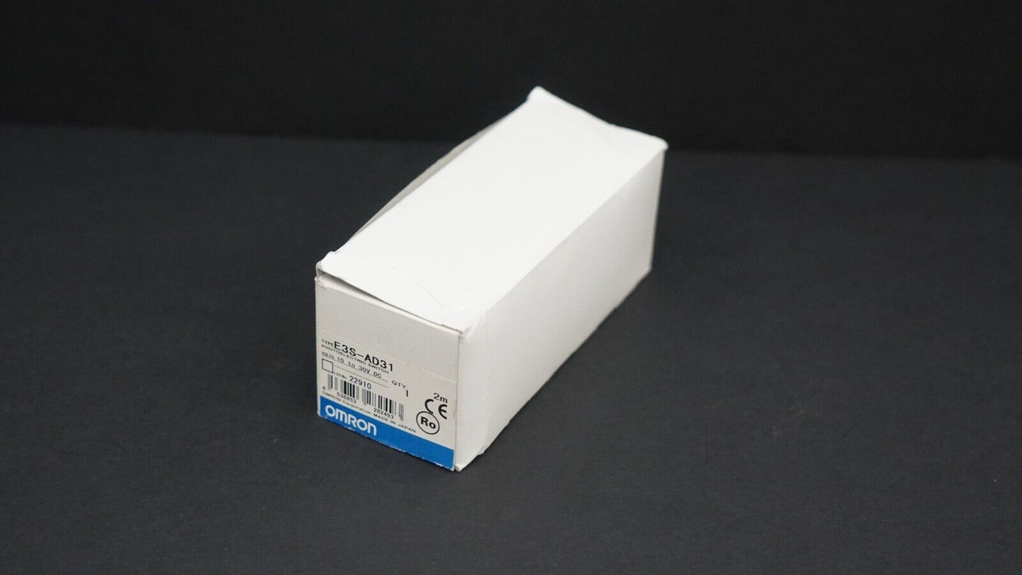 Omron E3S-AD31 photoelectric sensor in packaging, white box with product details, industrial automation.