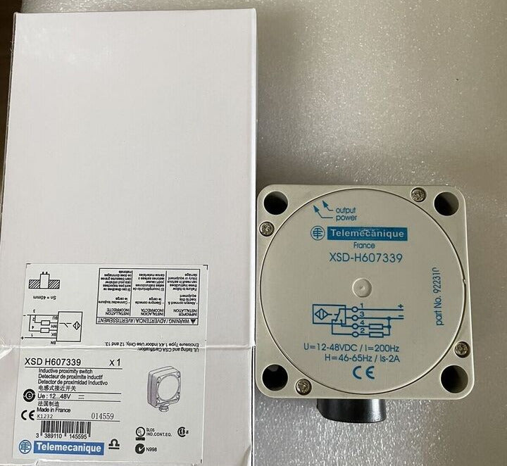 Schneider Electric XSD-H607339 inductive proximity sensor, white casing, and box.