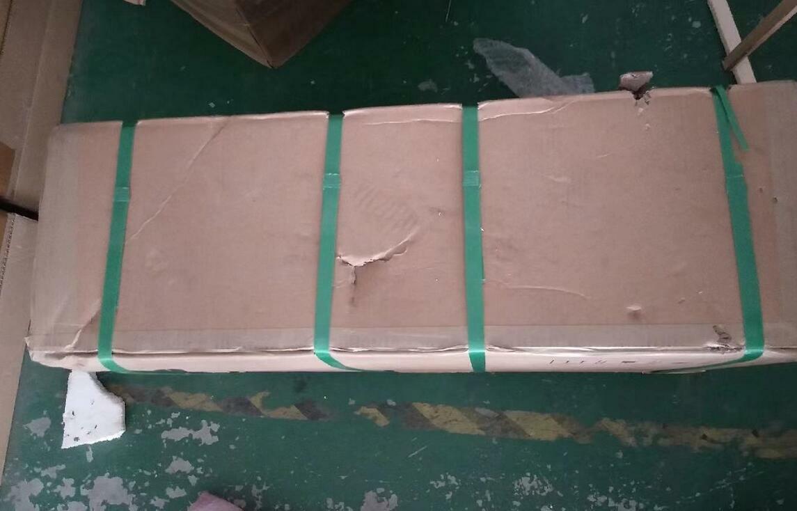 ABB ACS880-01 VFD in a large cardboard box secured with green straps, ready for shipping.