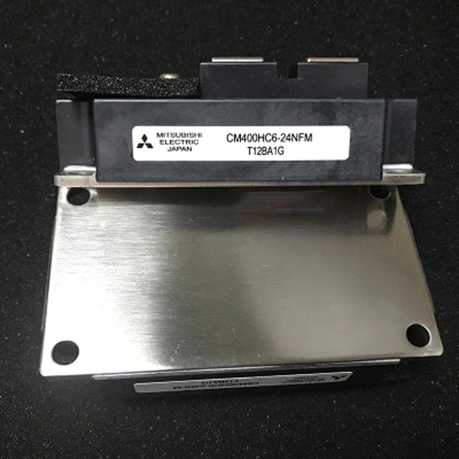 Mitsubishi CM400HC6-24NFM IGBT module industrial automation part. Black component with metallic base, Japan.