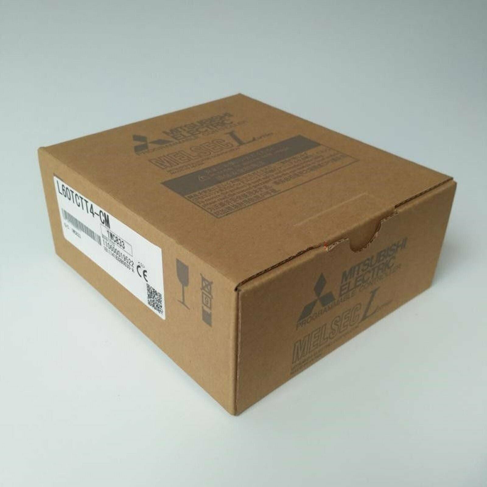 Mitsubishi L60TCTT4-CM PLC module in a cardboard box, product packaging
