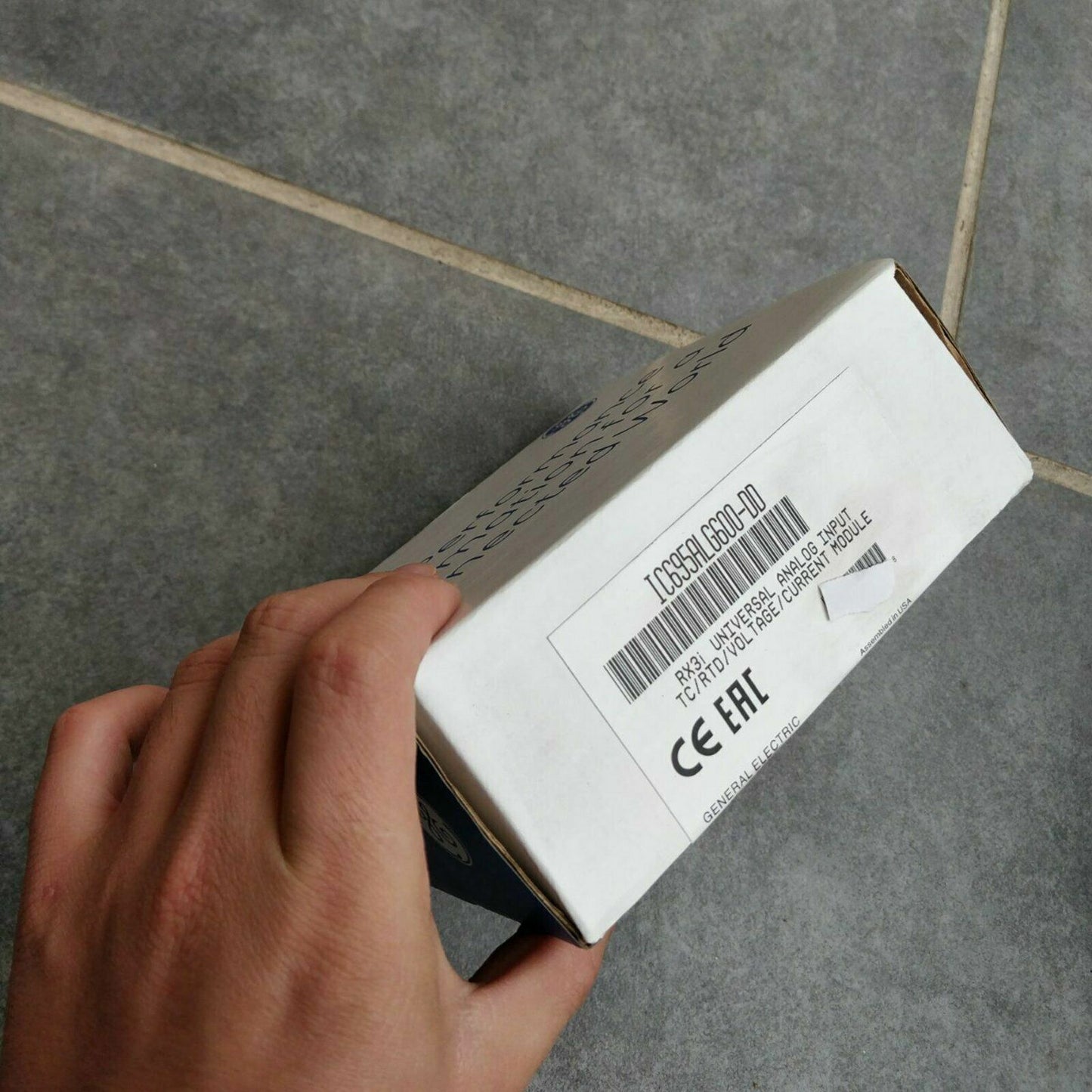 FANUC IC695ALG600-DD Universal Analog Input Module box, General Electric RX3i PLC part, held in hand.