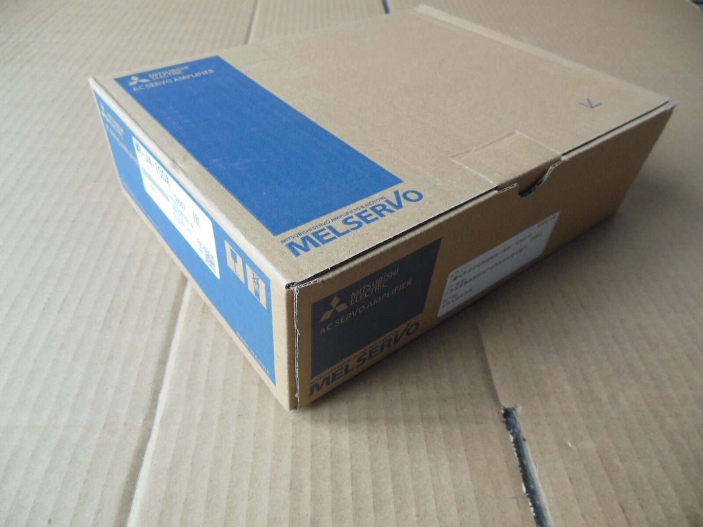 Mitsubishi MR-J4-100A Servo Drive box, new in box. MELSERVO AC Servo Amplifier, product details visible.