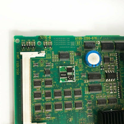 FANUC A16B-3200-0780 PLC module, green PCB with integrated circuits and components, a crucial part for FANUC Robot control.