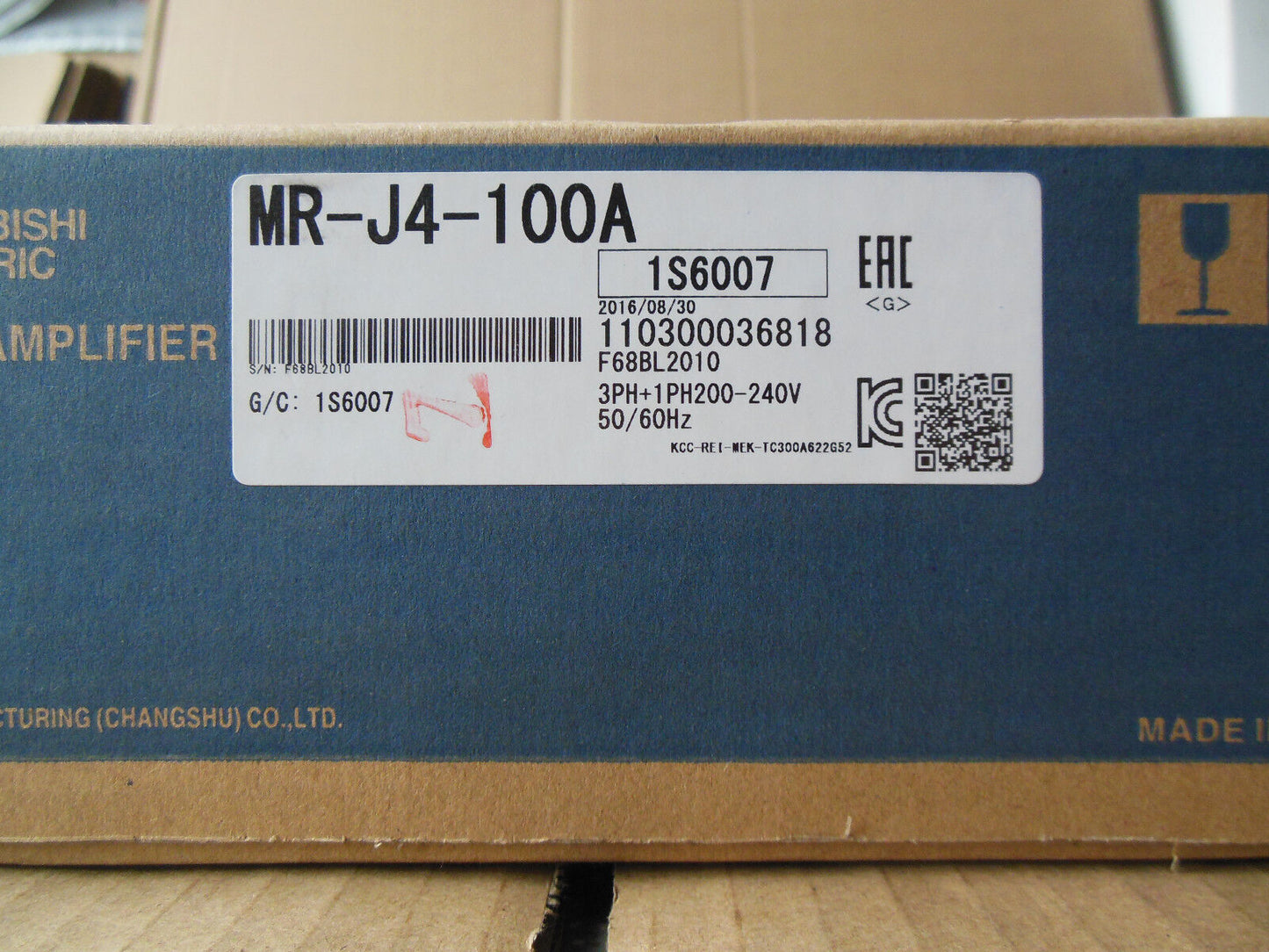 Mitsubishi MR-J4-100A Servo Drive box. Featuring product information label with model number and specifications.