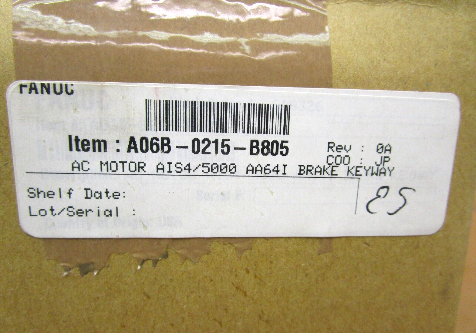 FANUC A06B-0215-B805 servo motor label.  Product details and barcode on a cardboard box for industrial automation.