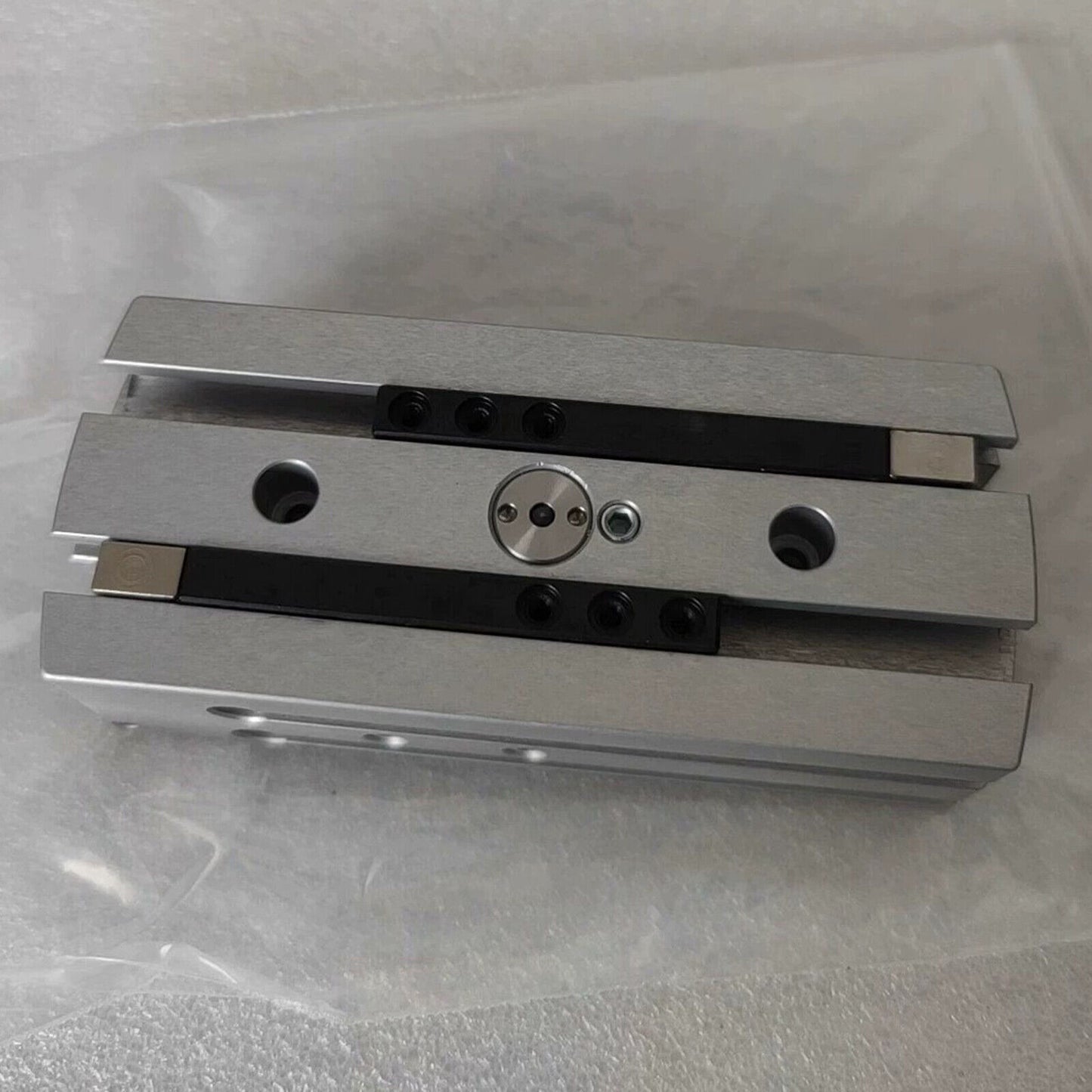 Festo HGPL-14-40-A-B Cylinder Claw, silver metal component with black accents, top view.