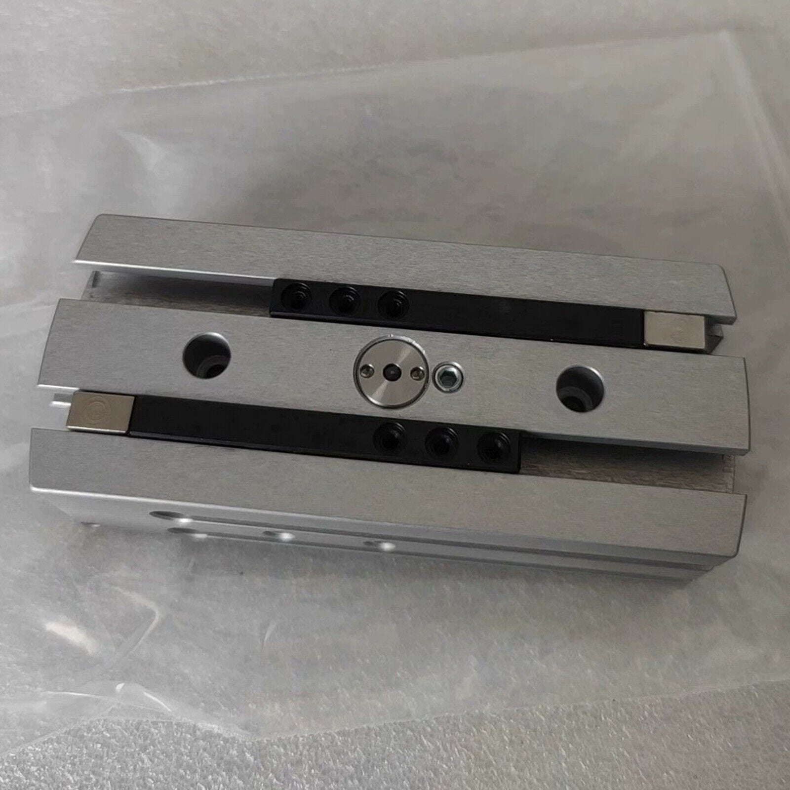 Festo HGPL-14-40-A-B Cylinder Claw, silver metal component with black accents, top view.