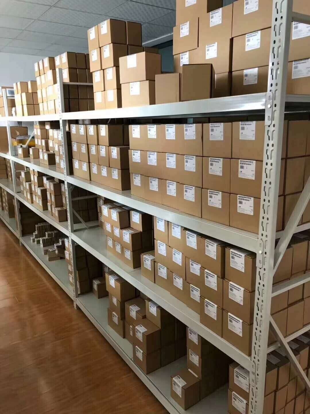 Omron PLC CPM1A-30CDR-A-V1 in boxes on warehouse shelves. New industrial automation parts with warranty.