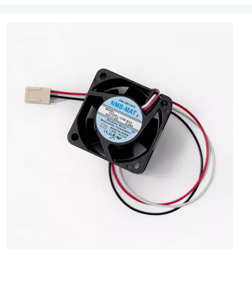 FANUC A90L-0001-0510 24V cooling fan. Black blades, white label, red, black, and white wires.
