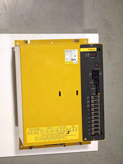 FANUC A06B-6134-H303#A Servo Drive. Yellow industrial automation equipment with display and ports.