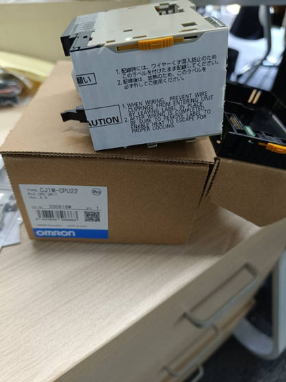 Omron CJ1M-CPU22 PLC CPU Unit in box, new condition, with product information label.