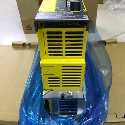 FANUC A06B-6222-H015#H610 Servo Amplifier. Yellow industrial automation part with warning labels.