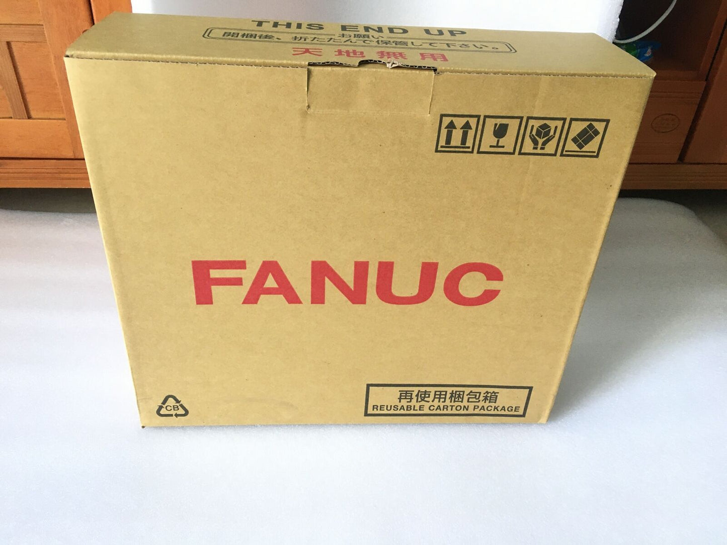 FANUC Spindle Amplifier box, brown cardboard packaging with handling instructions, automation part