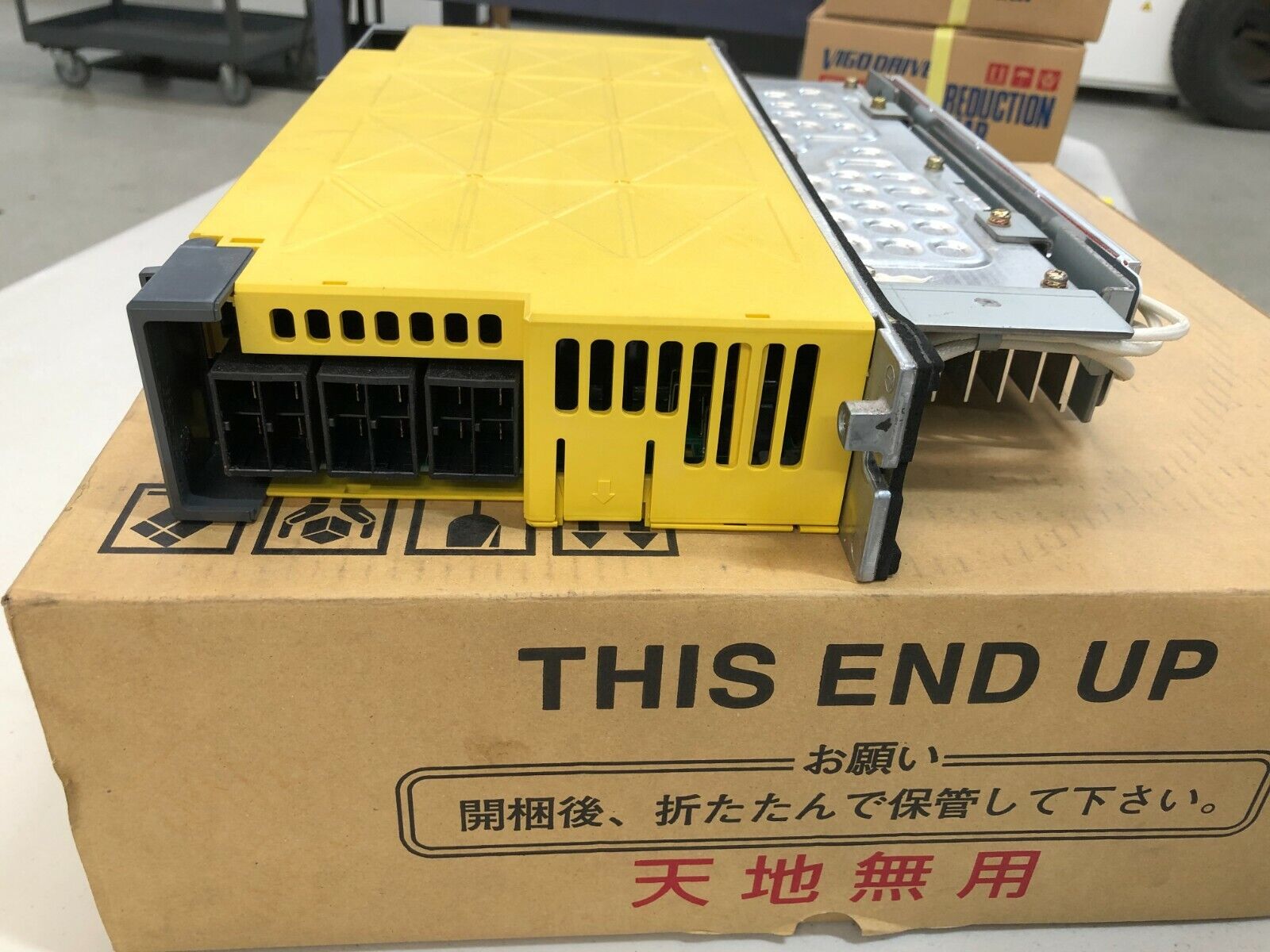 FANUC A06B-6130-H004 Servo Amplifier, yellow industrial component on box, 'THIS END UP' printed