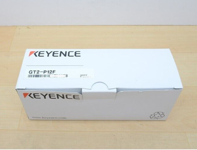 Keyence GT2-P12F sensor packaging box, white cardboard, with product name.
