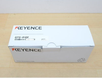 Keyence GT2-P12F sensor packaging box, white cardboard, with product name.