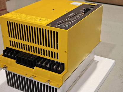 FANUC A06B-6134-H303#A Servo Drive: Yellow industrial automation equipment with black ports and heat sink.