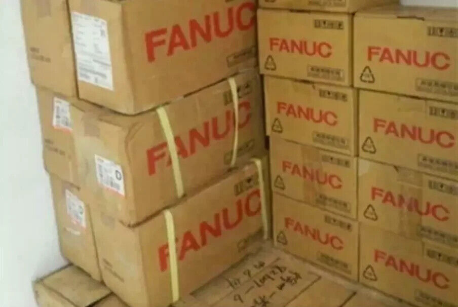 Stack of FANUC servo drive boxes, new industrial automation parts, in stock, free shipping.