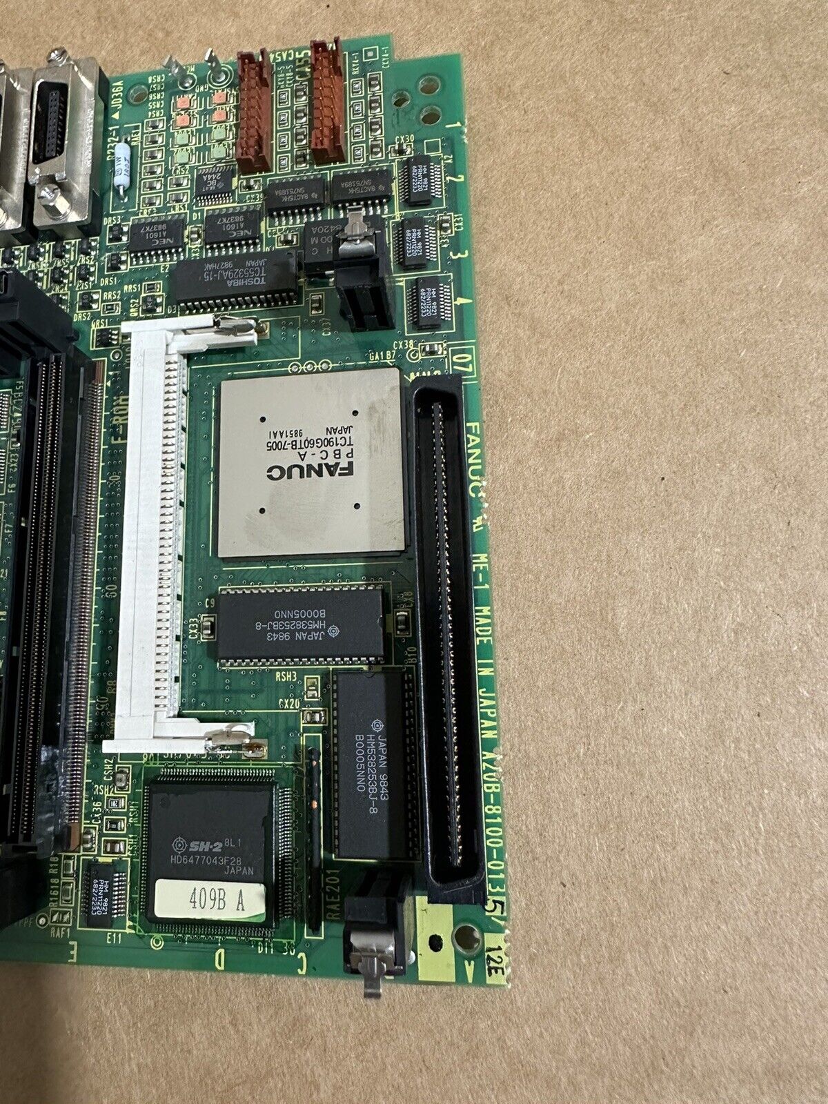 FANUC A20B-8100-0135 PCB Main Board: Green circuit board with electronic components, Made in Japan.