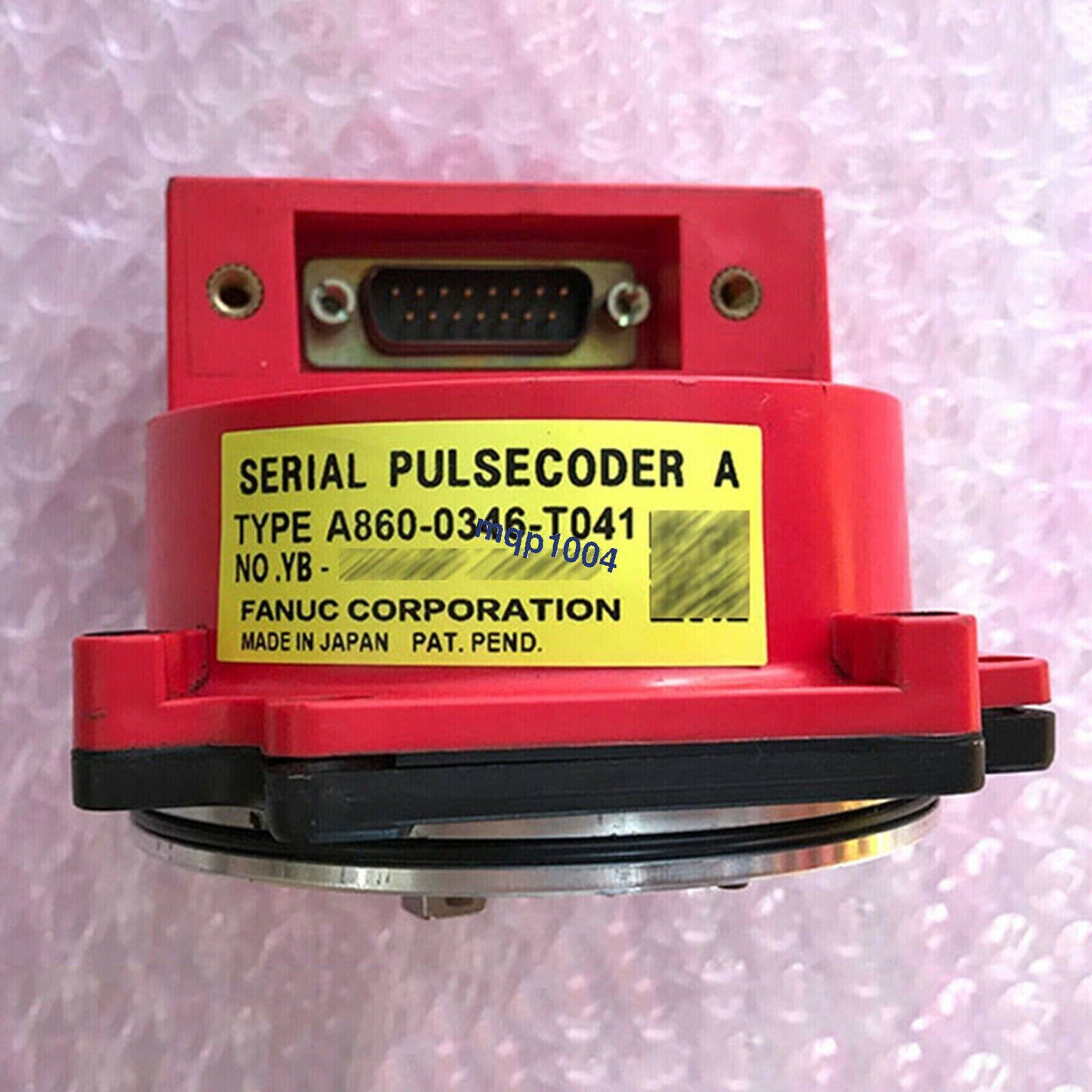 FANUC A860-0346-T041 encoder, red industrial automation part with a yellow label and serial number.