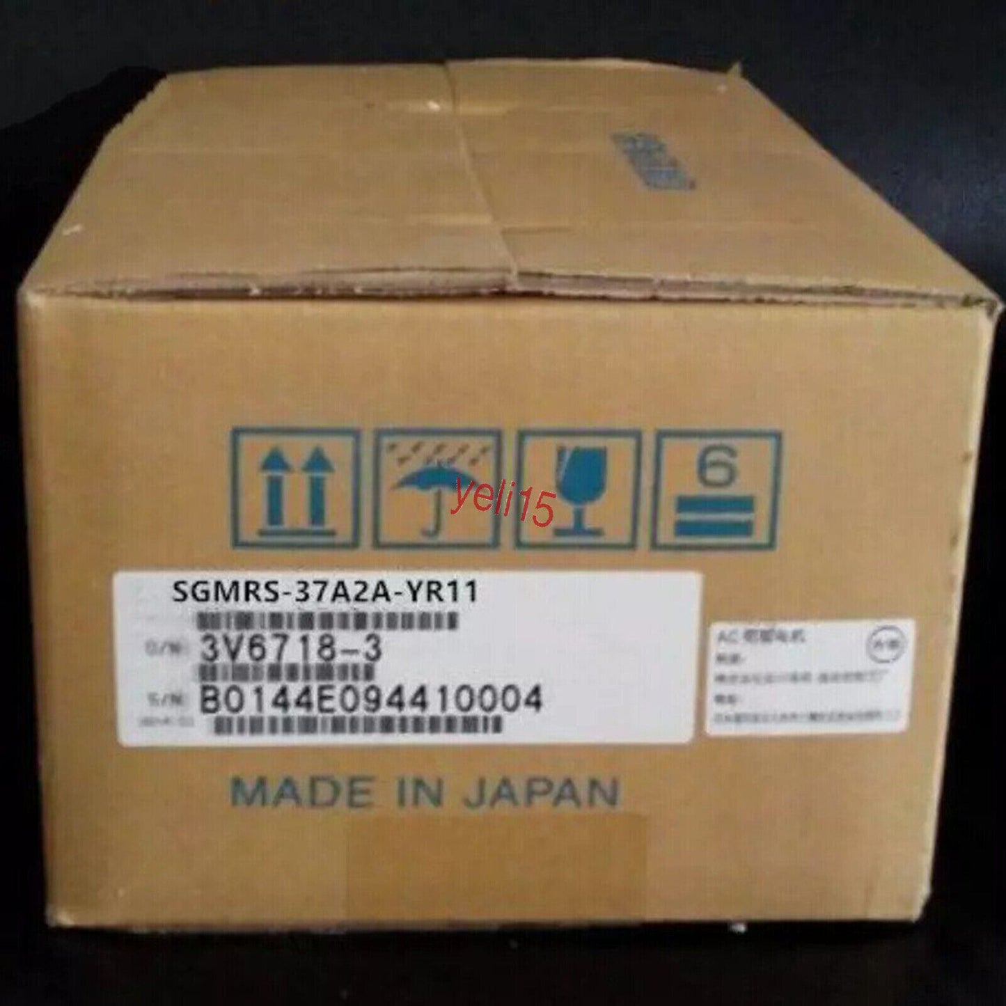 Yaskawa SGMRS-37A2A-YR11 AC Servo Motor in a cardboard box, Made in Japan, with product labels and shipping symbols.
