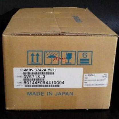 Yaskawa SGMRS-37A2A-YR11 AC Servo Motor in a cardboard box, Made in Japan, with product labels and shipping symbols.