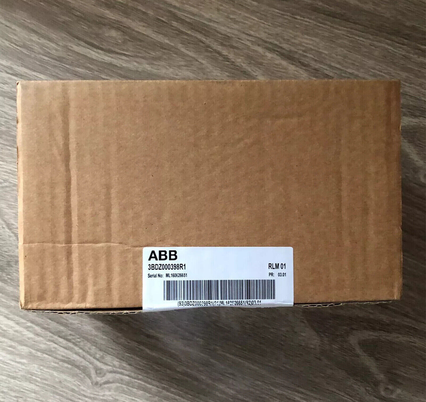 ABB RLM01 3BDZ000398R1 module on cardboard box, PLC automation part